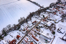 Oblique view of Main street in snow in Vollmersweiler in the state Rhineland-Palatinate, Germany