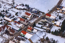 Oblique view of Main street in winter in the snow in the district Kleinsteinfeld in Niederotterbach in the state Rhineland-Palatinate, Germany