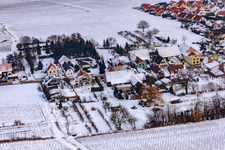 Main street in winter in the snow in the district Kleinsteinfeld in Niederotterbach in the state Rhineland-Palatinate, Germany from above