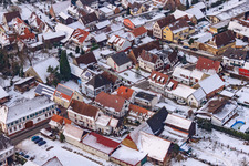 Main street in winter in the snow in Barbelroth in the state Rhineland-Palatinate, Germany