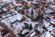 Church in the snow in Barbelroth in the state Rhineland-Palatinate, Germany seen from above