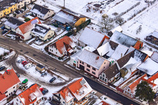 Oblique view of Main street in winter in the snow in Hergersweiler in the state Rhineland-Palatinate, Germany