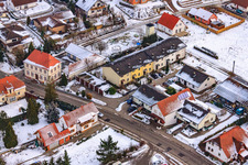 Main street in winter in the snow in Hergersweiler in the state Rhineland-Palatinate, Germany out of the air