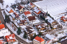 Main street in winter in the snow in Hergersweiler in the state Rhineland-Palatinate, Germany seen from above