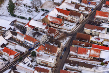 Main street in winter in the snow in Winden in the state Rhineland-Palatinate, Germany