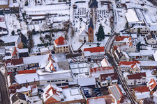 Aerial view of Raiffeisenstraße x Kirchstraße in snow in Winden in the state Rhineland-Palatinate, Germany