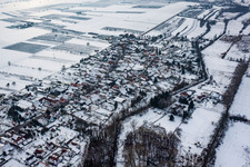 Aerial view of Wintry snowy Village - view on the edge of agricultural fields and farmland in Winden in the state Rhineland-Palatinate, Germany