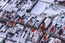 Kreuzgasse in the snow in Steinweiler in the state Rhineland-Palatinate, Germany from above