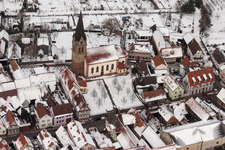 Aerial view of Wintry snowy Catholic Church building in the village of in Steinweiler in the state Rhineland-Palatinate, Germany