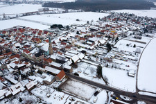 Aerial view of Kandeler Straße x Hauptstraße in winter with snow in Erlenbach bei Kandel in the state Rhineland-Palatinate, Germany