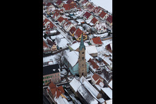 Winter snow-covered church buildings in the village center in Erlenbach bei Kandel in the state Rhineland-Palatinate, Germany