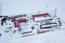 Aerial photograpy of Chicken farm egg farm in winter with snow in Erlenbach bei Kandel in the state Rhineland-Palatinate, Germany