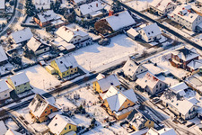 Raiffeisenstraße in winter with snow in Rheinzabern in the state Rhineland-Palatinate, Germany from above