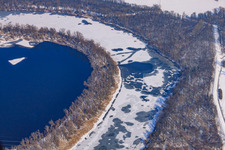 Frozen Althrein Kleiner Bodensee in winter with snow in the district Neureut in Karlsruhe in the state Baden-Wuerttemberg, Germany