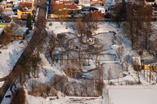 Swan pond frozen in winter in Kandel in the state Rhineland-Palatinate, Germany seen from above