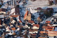 Wintry snowy Town View of the streets and houses of the residential areas in the district Ingenheim in Billigheim-Ingenheim in the state Rhineland-Palatinate out of the air