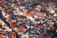 St. Michael's Collegiate Church and Parish Center in the town center in winter with snow in Klingenmünster in the state Rhineland-Palatinate, Germany