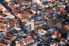 Protestant church in the town center in winter with snow in Klingenmünster in the state Rhineland-Palatinate, Germany