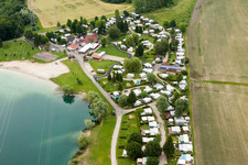 Camping with caravans and tents at the lake shore in Roeschwoog in Grand Est, France
