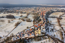Oblique view of St. Dionysius in Hinterstädel in winter with snow in Jockgrim in the state Rhineland-Palatinate, Germany