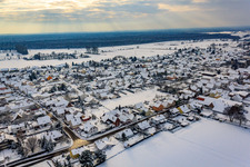 Main street in winter with snow in Minfeld in the state Rhineland-Palatinate, Germany