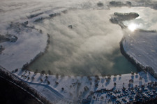 Riparian areas on the lake area of wintry snowy Bassin des Mouettes in Lauterbourg in Grand Est, France