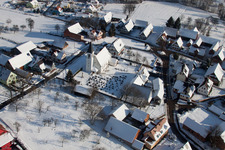 Oblique view of Wintry snowy Church building in the village of in Eberbach-Seltz in Grand Est, France
