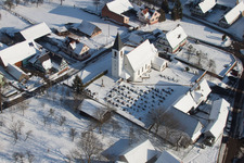 Wintry snowy Church building in the village of in Eberbach-Seltz in Grand Est, France from above
