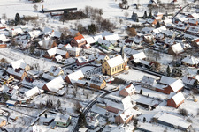 Wintry snowy Church building in the village of in Oberlauterbach in Grand Est, France