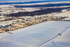 Village view from the southwest in snow in winter in the district Minderslachen in Kandel in the state Rhineland-Palatinate, Germany
