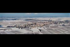 Wintry snowy Panoramic perspective Village - view on the edge of agricultural fields and farmland in Impflingen in the state Rhineland-Palatinate, Germany
