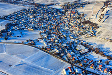 Village view below the small Kalmit from the southeast in snow in winter in Ilbesheim bei Landau in the state Rhineland-Palatinate, Germany