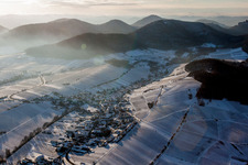 Aerial photograpy of Wintry snowy Village - view on the edge of snowed wine yards in Ranschbach in the state Rhineland-Palatinate, Germany