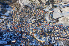 Aerial view of View of the town from the south in snow in winter in Albersweiler in the state Rhineland-Palatinate, Germany