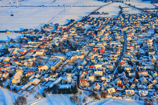 Eichstraße in the evening light during snow in winter in Minfeld in the state Rhineland-Palatinate, Germany