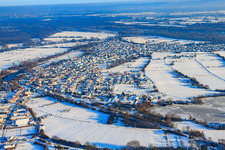 Oblique view of Village view in snow in winter from the west in Neuburg am Rhein in the state Rhineland-Palatinate, Germany