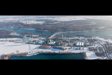 Wintry snowy Building and production halls on the premises of the chemical manufacturers DOW France S.A.S. at the river Rhine in Lauterbourg in Grand Est, France