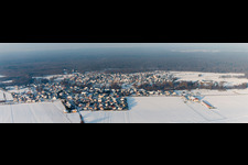 Wintry snowy Village - view on the edge of agricultural fields and farmland in Scheibenhard in Grand Est, France