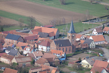 Aerial view of Village - view on the edge of agricultural fields and farmland in Geiswiller in Grand Est, France
