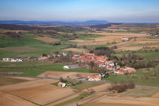 Village - view on the edge of agricultural fields and farmland in Issenhausen in Grand Est, France