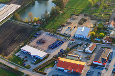 Im Riegel commercial area with Schuh-Hanss at the pond of the Herxheim Sports Fishing Association in Herxheim bei Landau in the state Rhineland-Palatinate, Germany