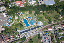 Bathers on the lawn by the pool of the swimming pool Albgau Freibad in Ettlingen in the state Baden-Wurttemberg