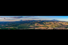 Panoramic perspective of Rocky and mountainous landscape with Paraglider in Montepulciano in Toskana, Italy