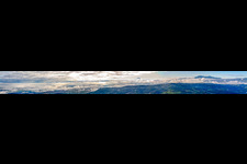 Panoramic perspective of Rocky and mountainous landscape with clouds and paraglider in Montepulciano in Toskana, Italy