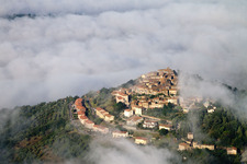 View of the town with high fog cloud layer over streets and houses of the residential areas in the district Civitella Marittima in Civitella Paganico in the state Grosseto, Italy