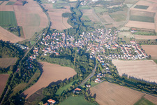 Aerial view of Village - view on the edge of agricultural fields and farmland in Ebertsheim in the state Rhineland-Palatinate