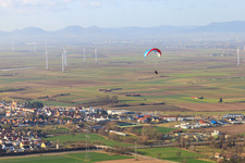 Paraglider over the Nordring industrial area in Rülzheim in the state Rhineland-Palatinate, Germany