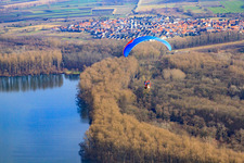 Paraglider over the Saalbach Canal in the district Rußheim in Dettenheim in the state Baden-Wuerttemberg, Germany