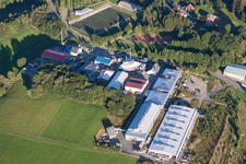 Aerial view of Industrial estate and company settlement with Morton Extrusionstechnik GmbH zu Fuessen des Sendemast in Abtsteinach in the state Hesse, Germany