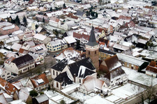 Church in winter with snow in the district Schaidt in Wörth am Rhein in the state Rhineland-Palatinate, Germany